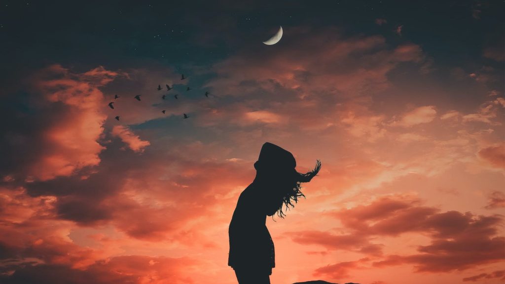 Person looking at moon: Photo by Alexandro David on Pexels